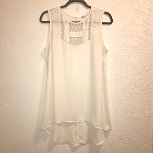 Cream high-low blouse.